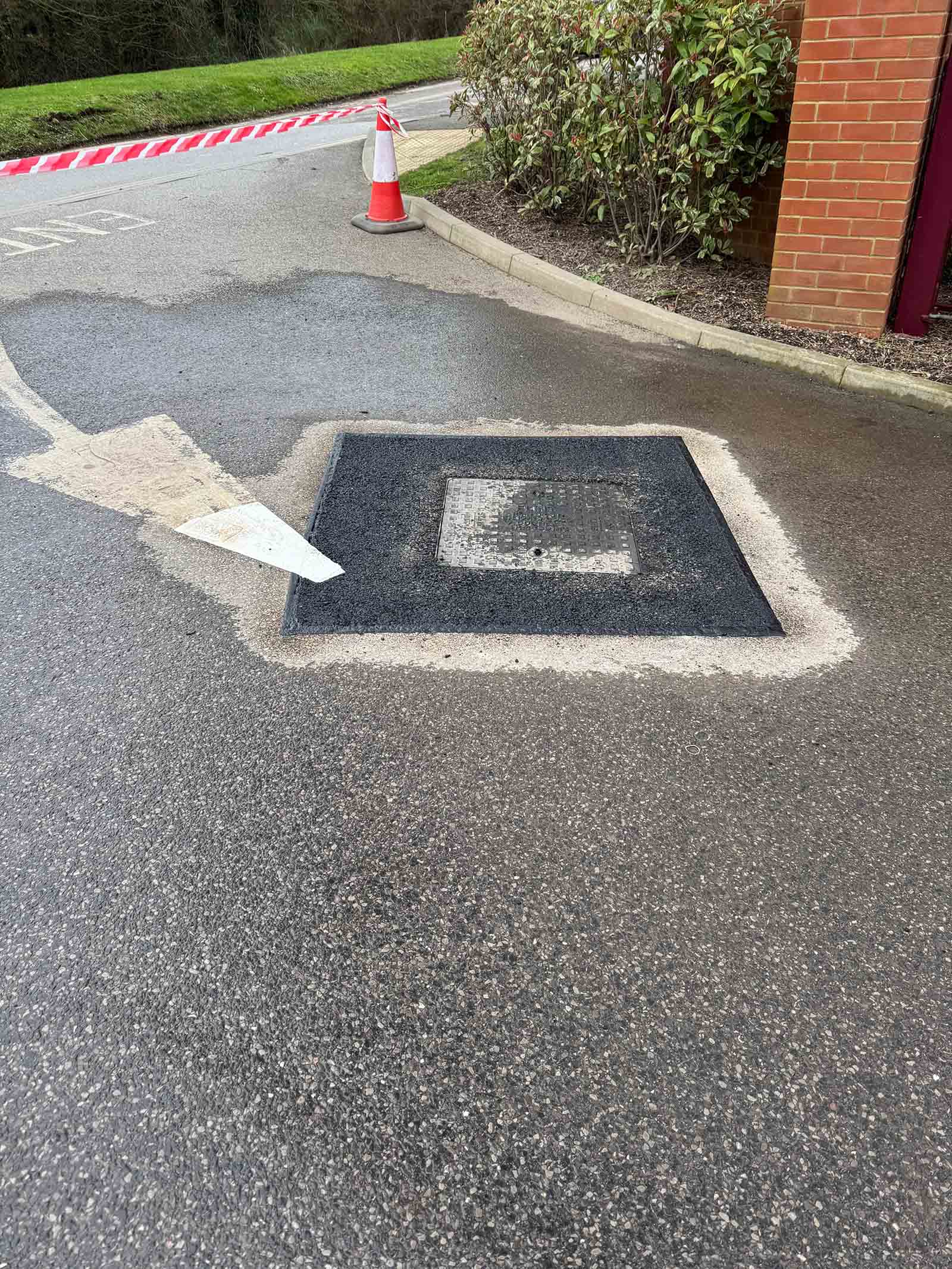 Utility cover tarmac surface repair in Weybridge
