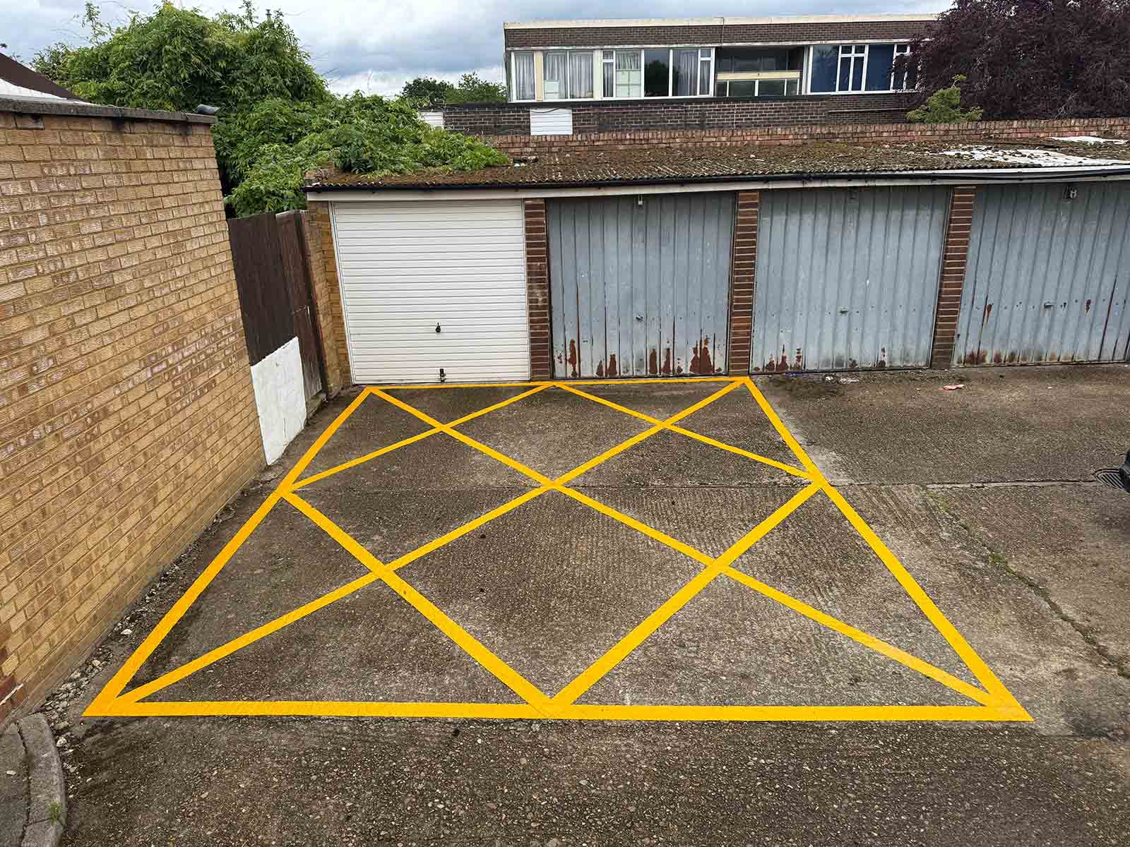 Yellow box line marking for garage access in Surrey